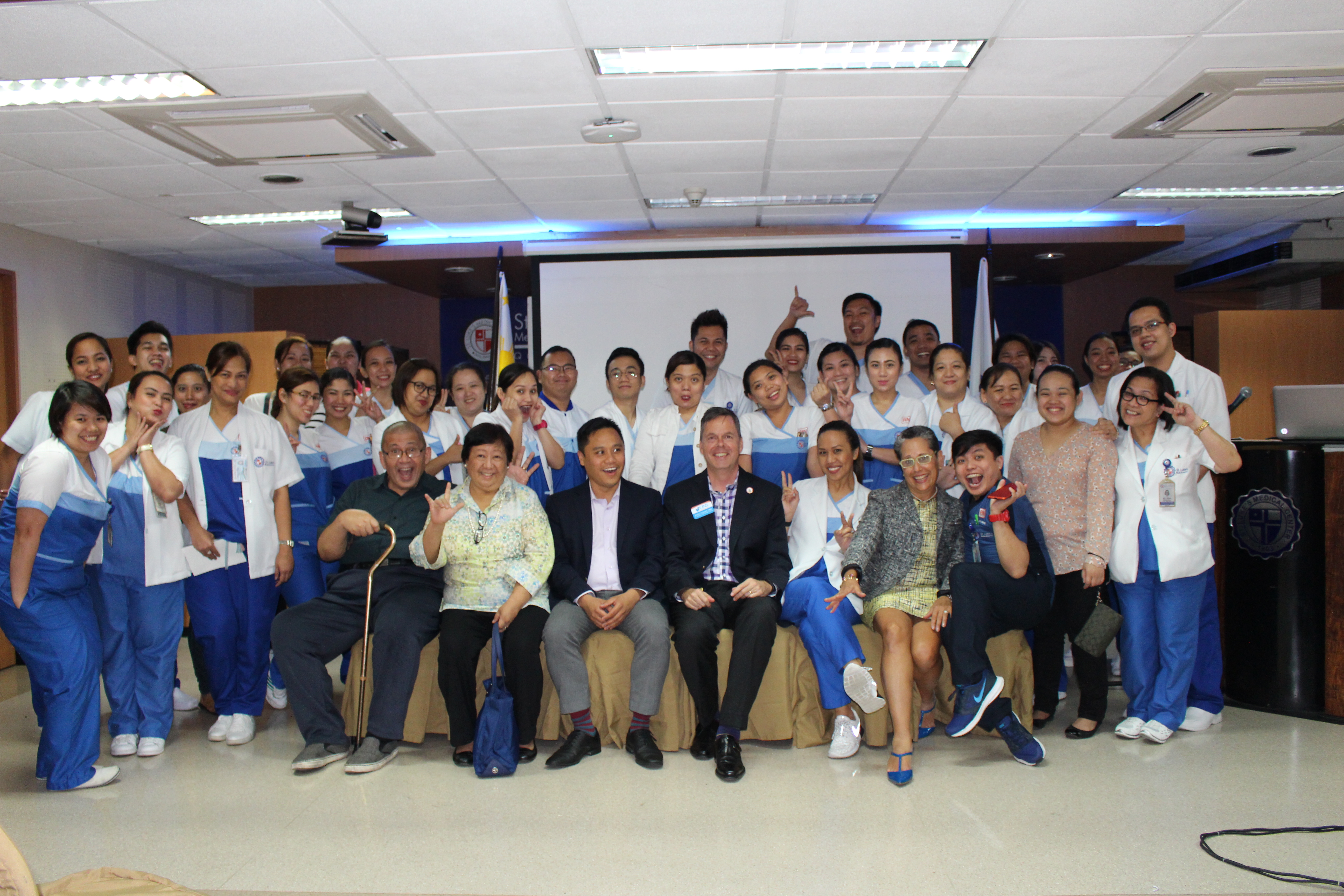 Group of professionals posing for a photo at a conference